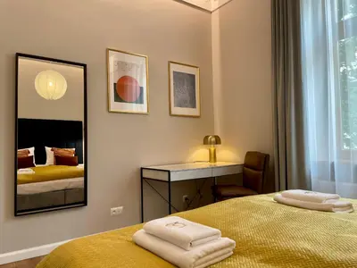 a bedroom with a bed with two towels on it at Golden Queen Apartments City Center in Kraków