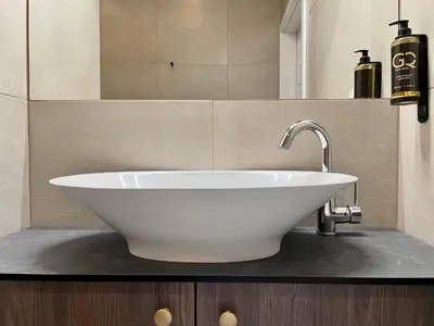 a bathroom with a white sink and a mirror at Golden Queen Apartments City Center in Kraków