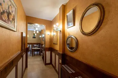 a hallway with mirrors on the walls of a bathroom at David Boutique ApartHotel in Kraków
