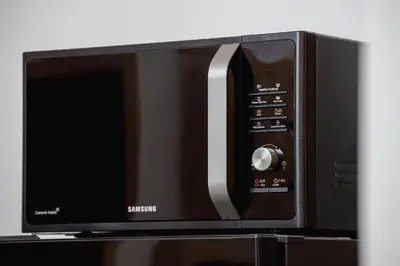 a microwave oven sitting on top of a shelf at Fabryczna City Kraków by Renters by Noclegi Renters in Kraków
