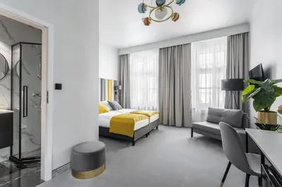 a hotel room with a bed and a couch at Old Town Residence Aparthotel in Kraków