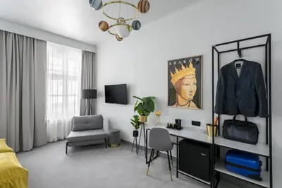a white room with a desk and a chair at Old Town Residence Aparthotel in Kraków