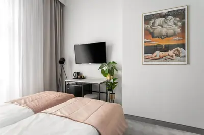 a bedroom with a bed and a desk with a television at Old Town Residence Aparthotel in Kraków