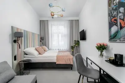 a bedroom with a bed and a desk in it at Old Town Residence Aparthotel in Kraków