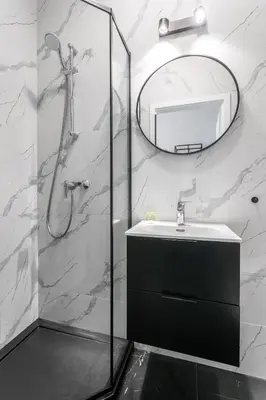 a bathroom with a shower and a sink and a mirror at Old Town Residence Aparthotel in Kraków