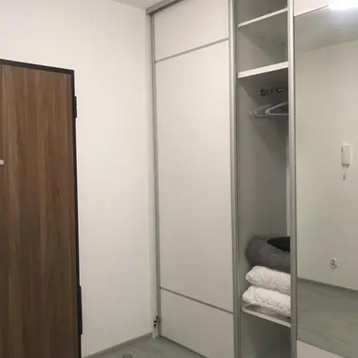 a walk in closet with a mirror and towels at Apartament BARCELONA in Kraków