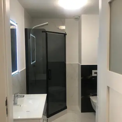 a bathroom with a shower and a sink at Apartament BARCELONA in Kraków