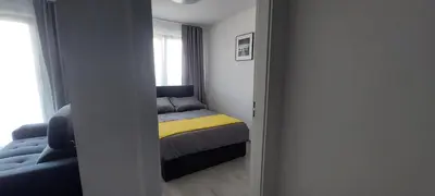 a small bedroom with a bed and a window at Apartament BARCELONA in Kraków
