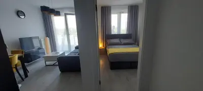 a small room with a bed and a couch at Apartament BARCELONA in Kraków