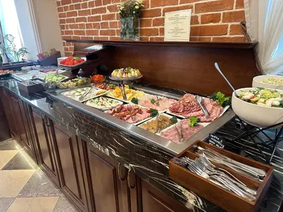 a buffet line with many different types of food at Aparthotel Basztowa in Kraków