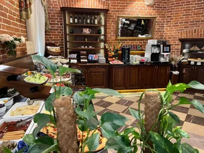 a restaurant with a counter with food on it at Aparthotel Basztowa in Kraków