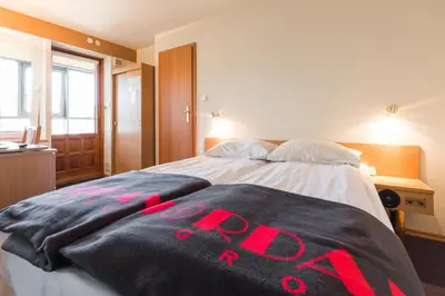 a bedroom with a bed with red writing on it at Jordan Pokoje Gościnne in Kraków