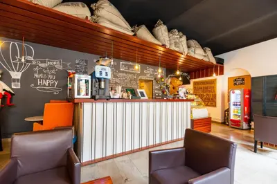 a restaurant with chairs and a bar with shoes on the wall at Jordan Pokoje Gościnne in Kraków