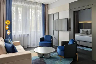 a living room with a couch and chairs and a bed at Garamond, a Tribute Portfolio Hotel, Krakow Old Town in Kraków