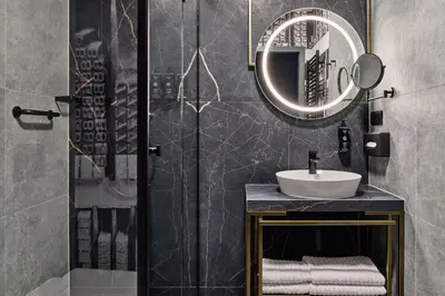 a bathroom with a sink and a mirror at Garamond, a Tribute Portfolio Hotel, Krakow Old Town in Kraków