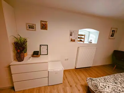 a bedroom with a white dresser and a mirror at Winnica NOVI - apartamenty in Cianowice Duże