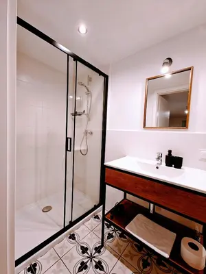 a bathroom with a sink and a shower at Winnica NOVI - apartamenty in Cianowice Duże
