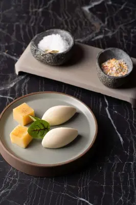 a plate of food with cheese and a bowl of rice at Radisson Blu Hotel Krakow in Kraków