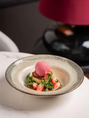 a dessert in a bowl with a scoop of ice cream at Radisson Blu Hotel Krakow in Kraków