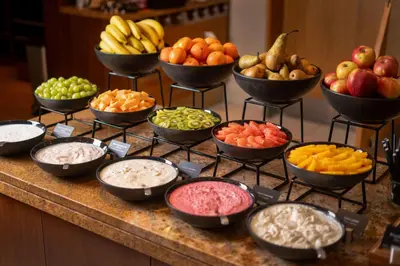 a buffet with bowls of different fruits and vegetables at Radisson Blu Hotel Krakow in Kraków