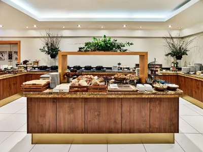 a buffet line with bread and pastries on a counter at Radisson Blu Hotel Krakow in Kraków