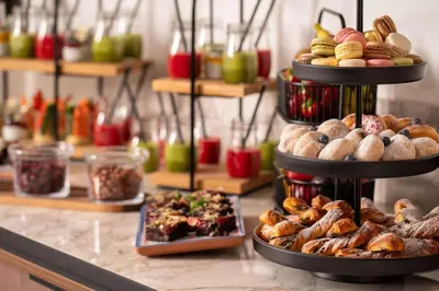 a display of different types of bread and pastries at Radisson Blu Hotel Krakow in Kraków