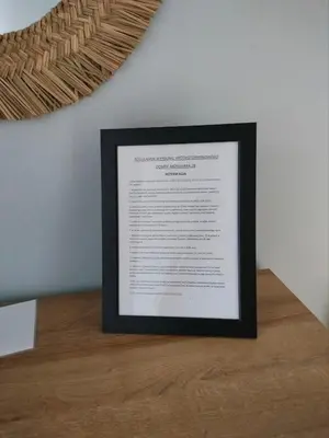 a framed picture on top of a wooden table at Domek Mordarka in Limanowa