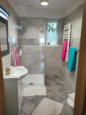 a bathroom with a shower and a sink and a toilet at Domek Mordarka in Limanowa