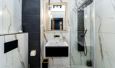 a bathroom with a sink and a mirror at Doris Day Apartment in Kraków