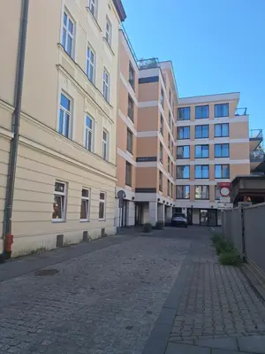 an empty street in front of a building at Doris Day Apartment in Kraków