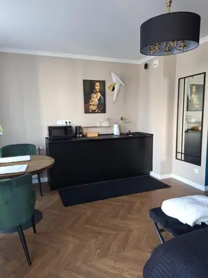 a living room with a counter and a table at Doris Day Apartment in Kraków