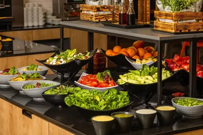 a buffet with many different types of food on display at Novotel Kraków City West in Kraków