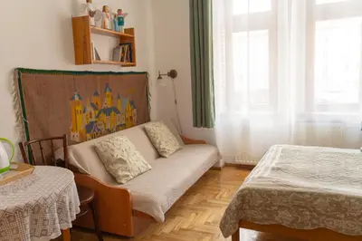 a living room with a couch and a bed at Kolory Guest House in Kraków