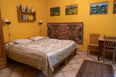 a bedroom with a bed and a table and chairs at Kolory Guest House in Kraków