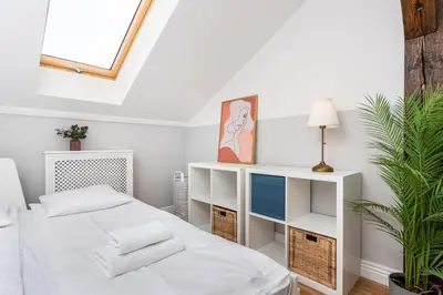 a white bedroom with a bed and a window at Riverside Premium Class Apartment - by Upstairs in Kraków