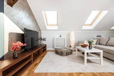 a living room with a couch and a tv at Riverside Premium Class Apartment - by Upstairs in Kraków