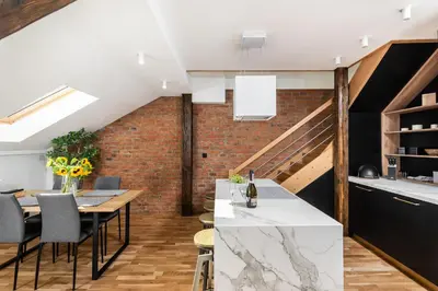 a kitchen and dining room with a brick wall at Riverside Premium Class Apartment - by Upstairs in Kraków