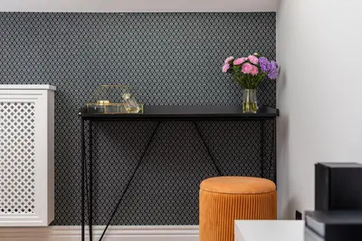 a black table with a vase of flowers and a stool at Riverside Premium Class Apartment - by Upstairs in Kraków