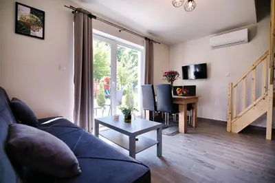 a living room with a couch and a table at HOUSE OF ENERGY - Zator Przeciszów in Przeciszów