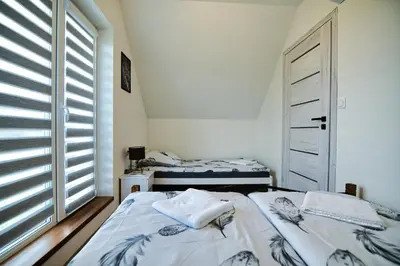 a bedroom with two beds and a window at HOUSE OF ENERGY - Zator Przeciszów in Przeciszów