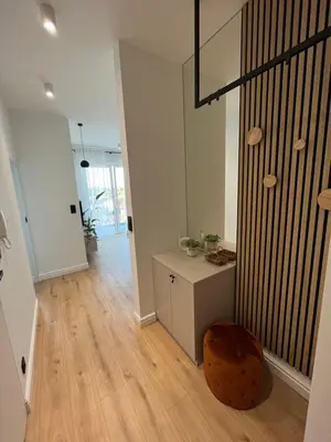 a living room with a staircase and a wooden floor at Apartament 4 piętro in Zator