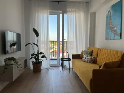 a living room with a couch and a balcony at Apartament 4 piętro in Zator