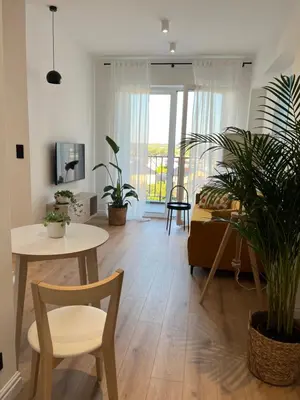 a living room with a table and a couch at Apartament 4 piętro in Zator
