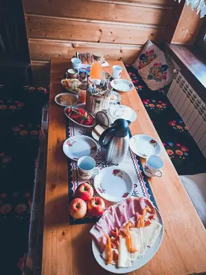 a wooden table with plates of food on it at Agroturystyka Górski Wypoczynek in Stryszawa