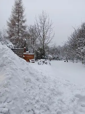 a pile of snow on the side of a driveway at Agroturystyka Górski Wypoczynek in Stryszawa