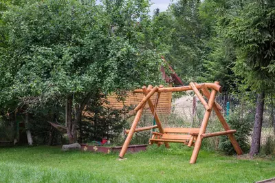a wooden swing set in a yard at Agroturystyka Górski Wypoczynek in Stryszawa