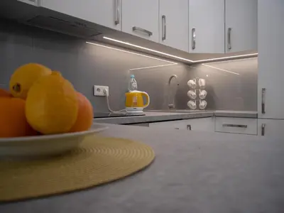 a bowl of oranges on a counter in a kitchen at Przytulny apartament z ogródkiem in Kraków
