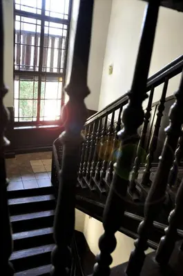 a spiral staircase in a building with a window at Station Aparthotel in Kraków