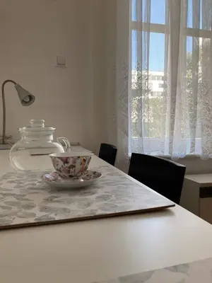 a table with a tea pot and a plate on it at Urocze mieszkanie w krakowskiej kamienicy in Kraków