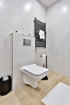 a bathroom with a white toilet in a room at Domki Pod Lasem MM in Rabka